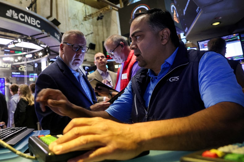 FILE PHOTO: Traders work on the floor of the NYSE in New York